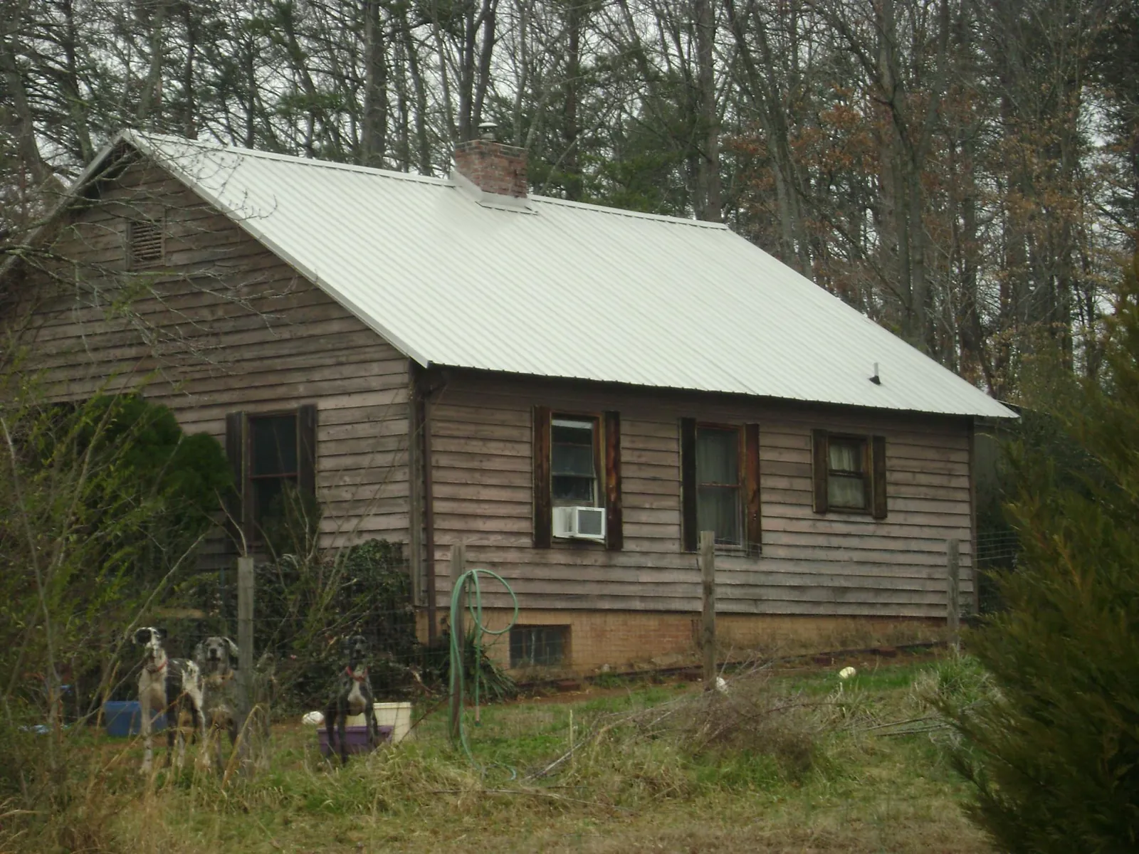 White metal roof on an old wood sided farmhouse, from a Metal Roof Installation job in Cornish